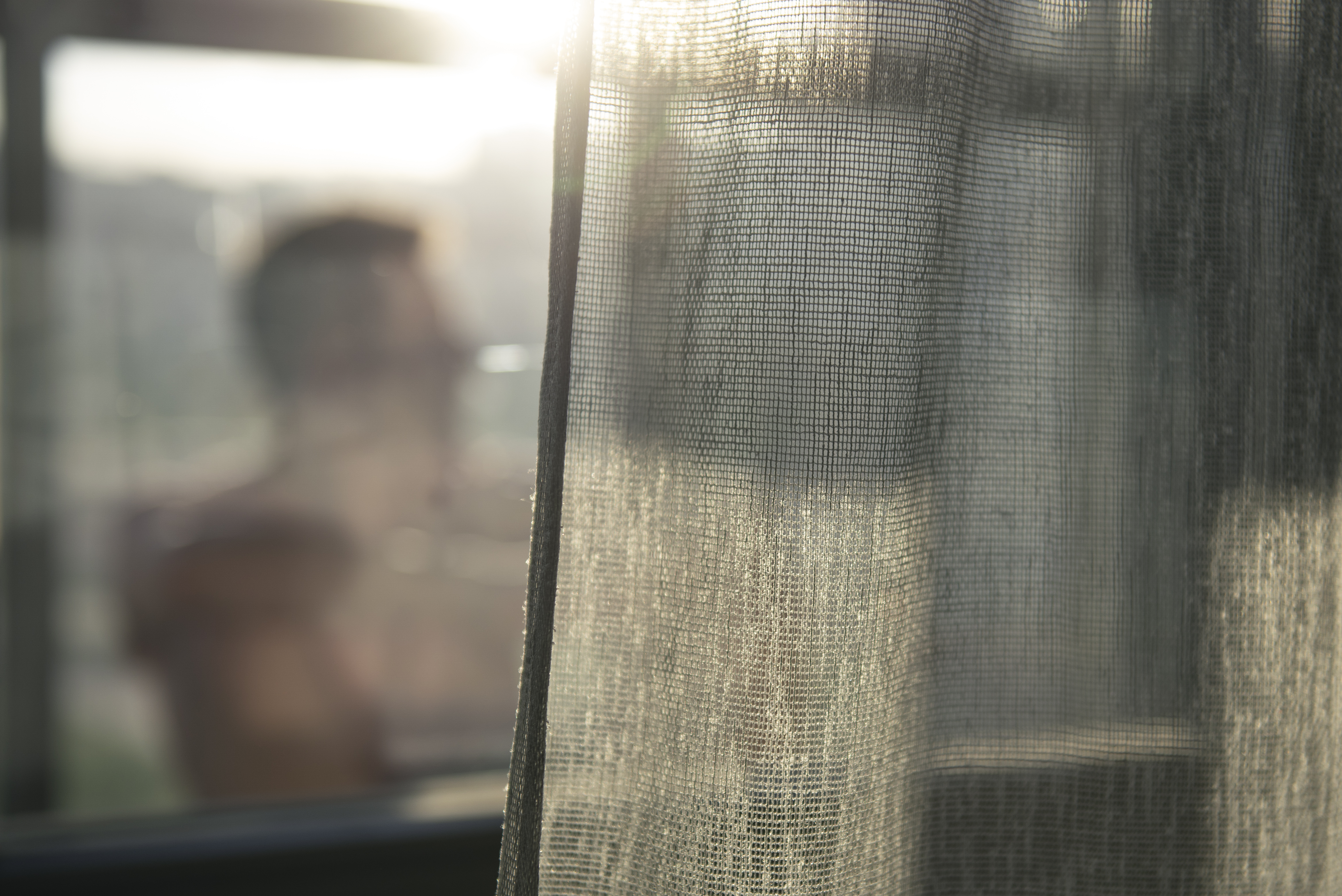 portrait-adult-man-with-curtains-shadow-from-window