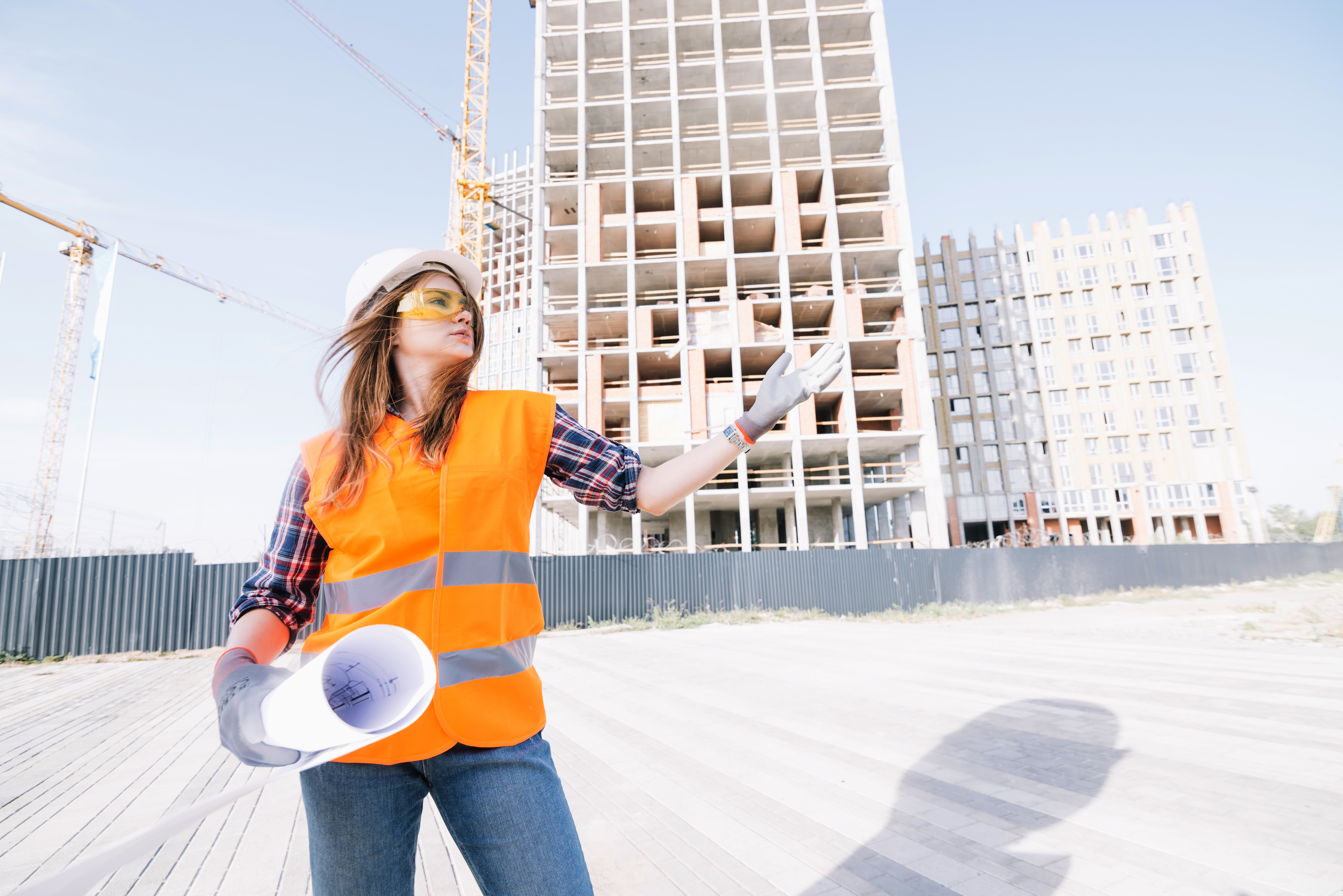 woman-with-draft-gesturing-construction-site
